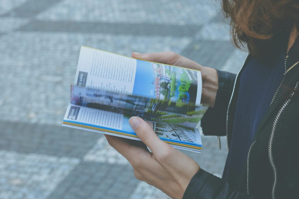  Customer Reading Printed Brochure To Demonstrate Print Retention And Brand Memory